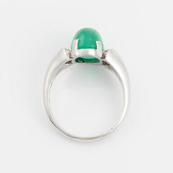An 18K white gold ring set with a cabochon-cut emerald and eight-cut diamonds.