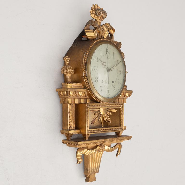 A Gustavian wall clock, late 18th century.