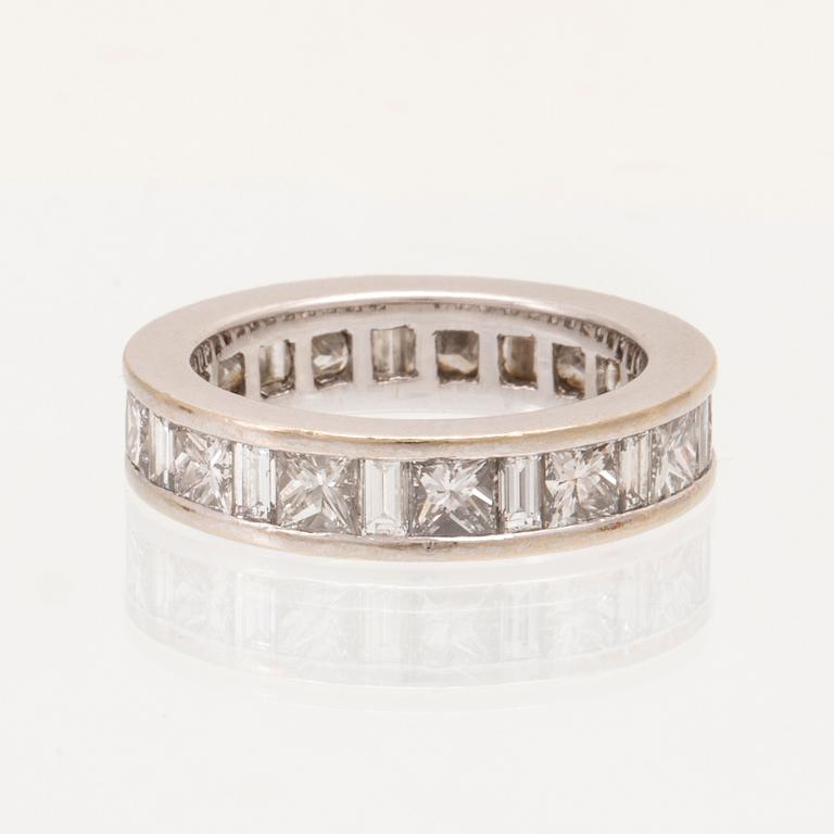 An 18K white gold eternity ring set with baguette and princess cut diamonds by Hartmann's Denmark.