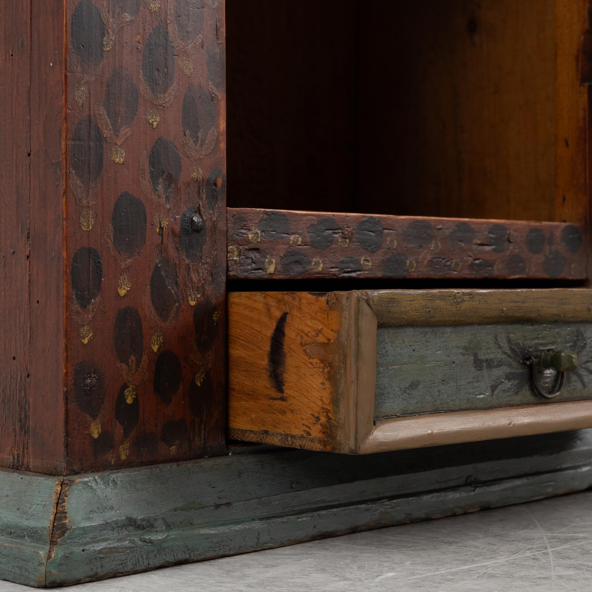A painted wall cabinet, dated 1817.
