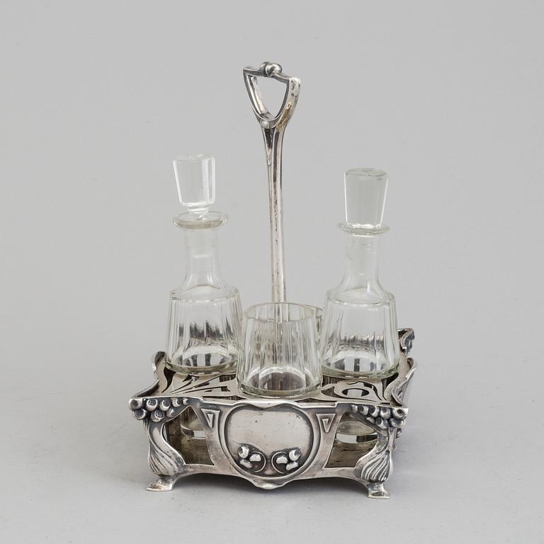 An Art Nouveau early 20th century silver cruet-set for four glass containers, unknown master.