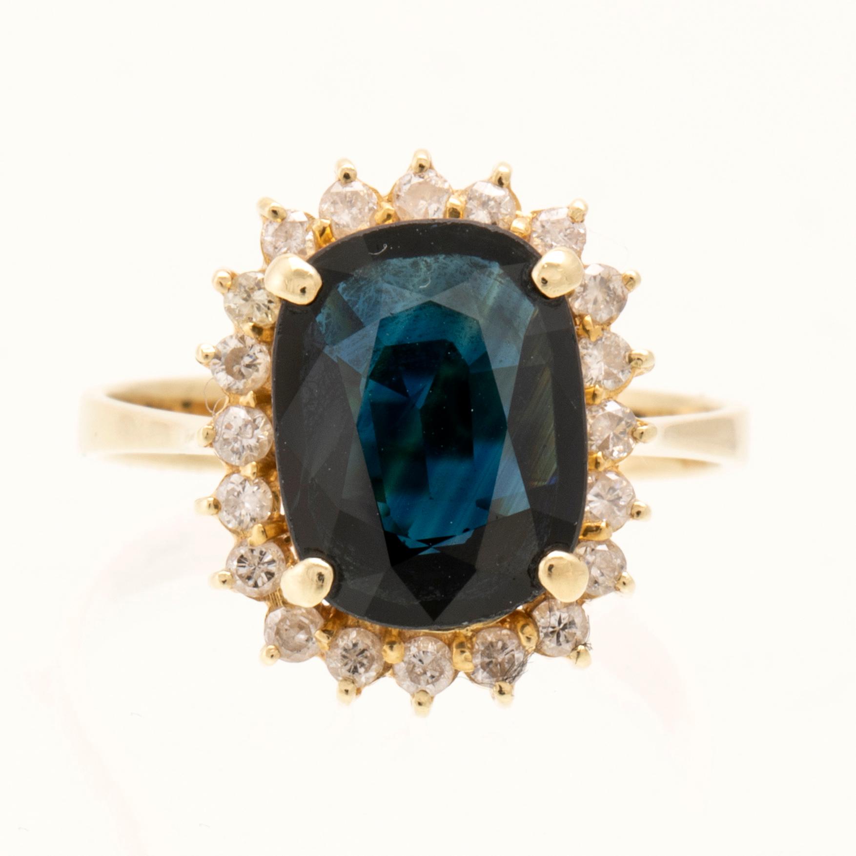 Ring in 14K gold with faceted sapphire and round brilliant-cut diamonds.