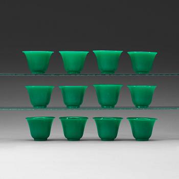 A set of 12 green peking glass wine cups, late Qing dynasty (1644-1912).