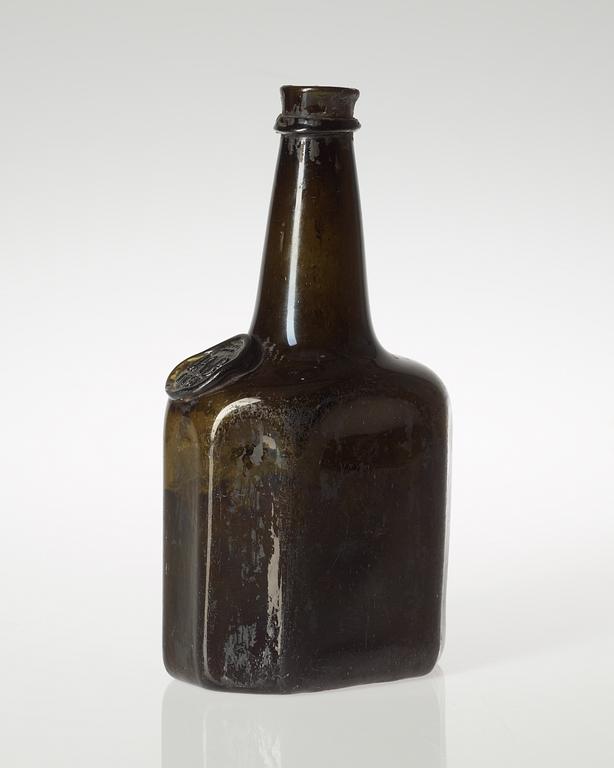 A Swedish green glass bottle, dated 1751.