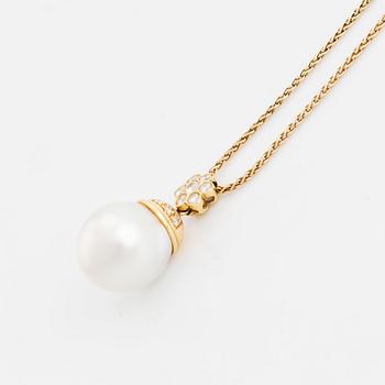 An 18K gold and cultured South Sea pearl pendant set with round brilliant-cut diamonds.