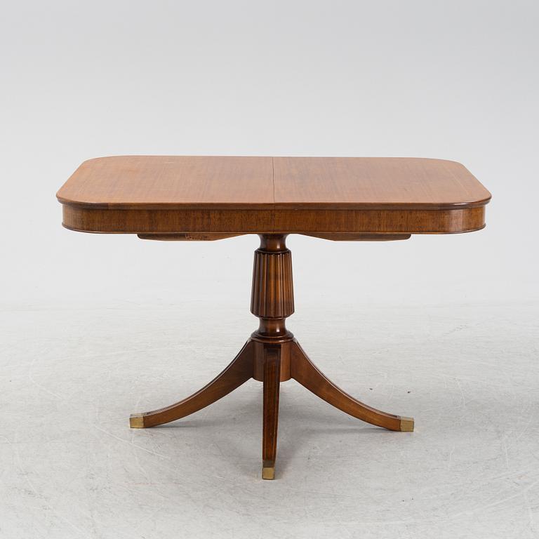 An mahogany veneered english style dining table, mid 20th century.