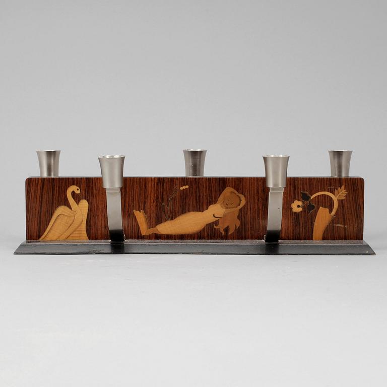 LJUSSTAKE, Mjölby Intarsia, 1900-talets första hälft.