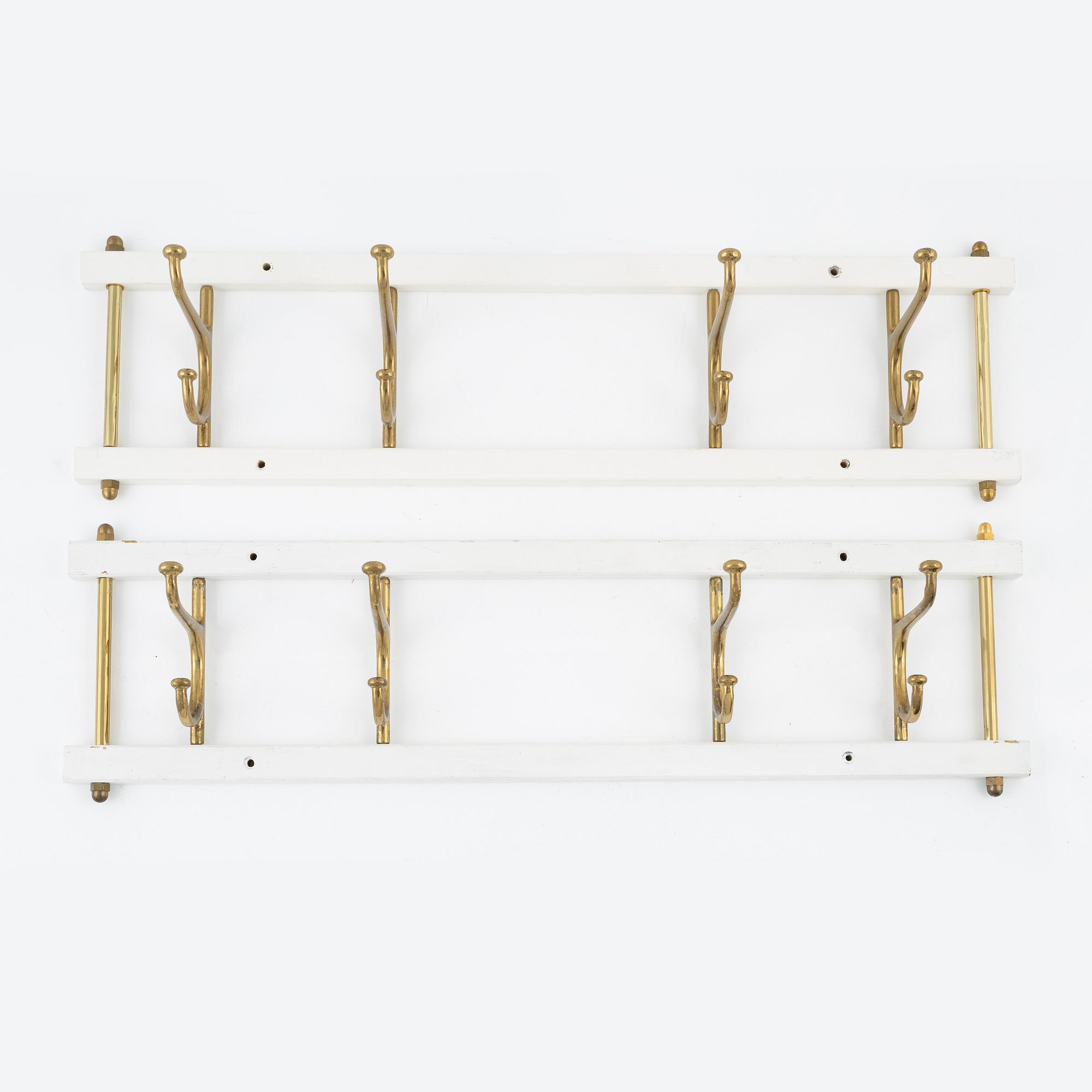 A pair of 'Dekorativ' coat hangers, Skoglunds metallgjuteri, Anderstorp, mid 20th Century.