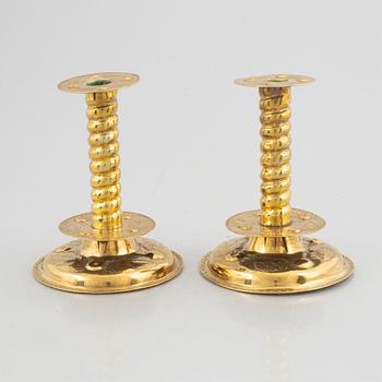 A pair of brass baroque style candlesticks, end of the 19th century.