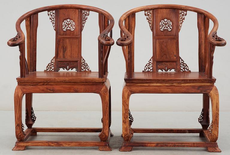 A pair of hardwood horseshoeback armchairs, late Qing dynasty, circa 1900.