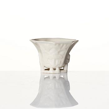 A lacquer tea box and a blanc de chine cup, Qing dynasty 18/19th century.