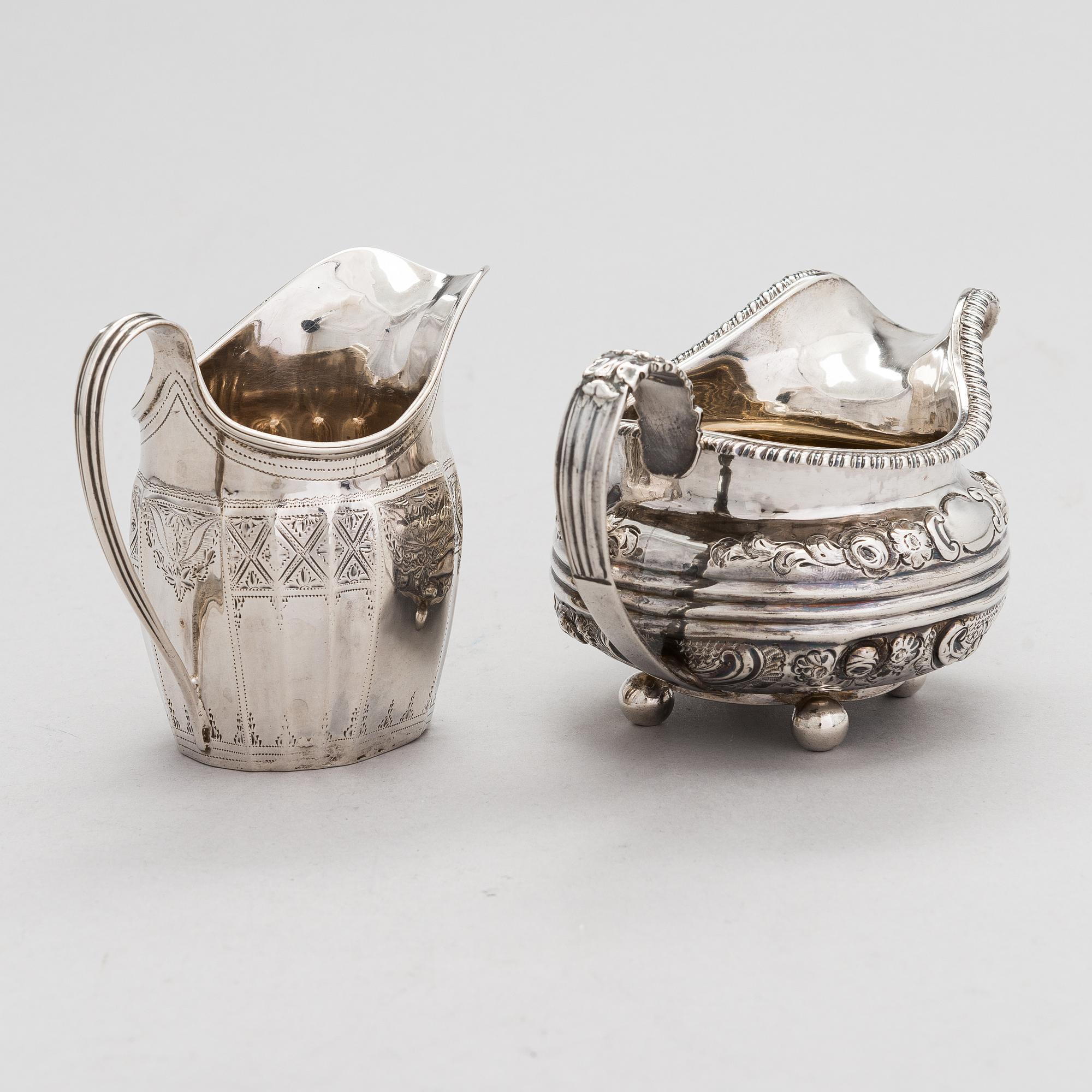Two sterling silver milk jugs, London 1794 och 1828.
