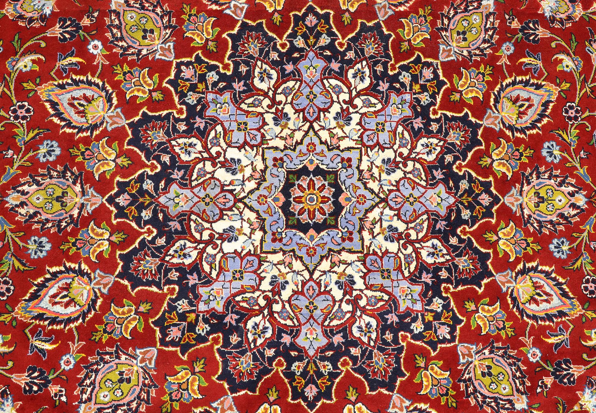 A Keshan carpet, part silk, signed, approx. 398 x 270 cm.