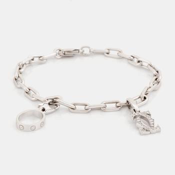 439. An 18K white gold Cartier "Spartacus" bracelet with two charms.