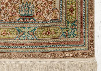 A semi-antique silk Hereke, c. 92 x 61 cm.