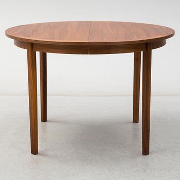 A second half of the 20th Century walnut veneered dinner table.