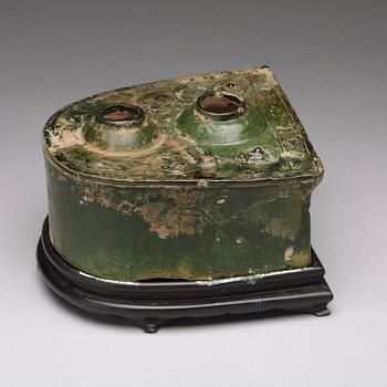 A green glazed pottery model of a stove, Han dynasty (206 BC-220 AD).