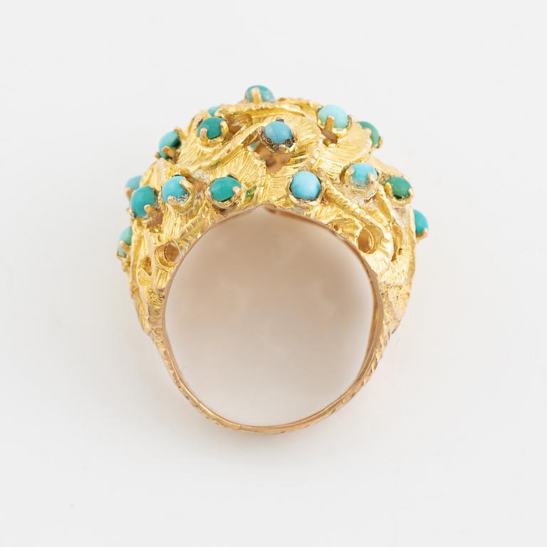 A 14K gold ring set with turquoises.