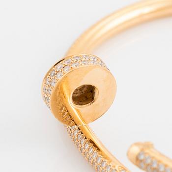 A Cartier "Juste un Clou" bracelet in 18K gold set with round brilliant-cut diamonds.