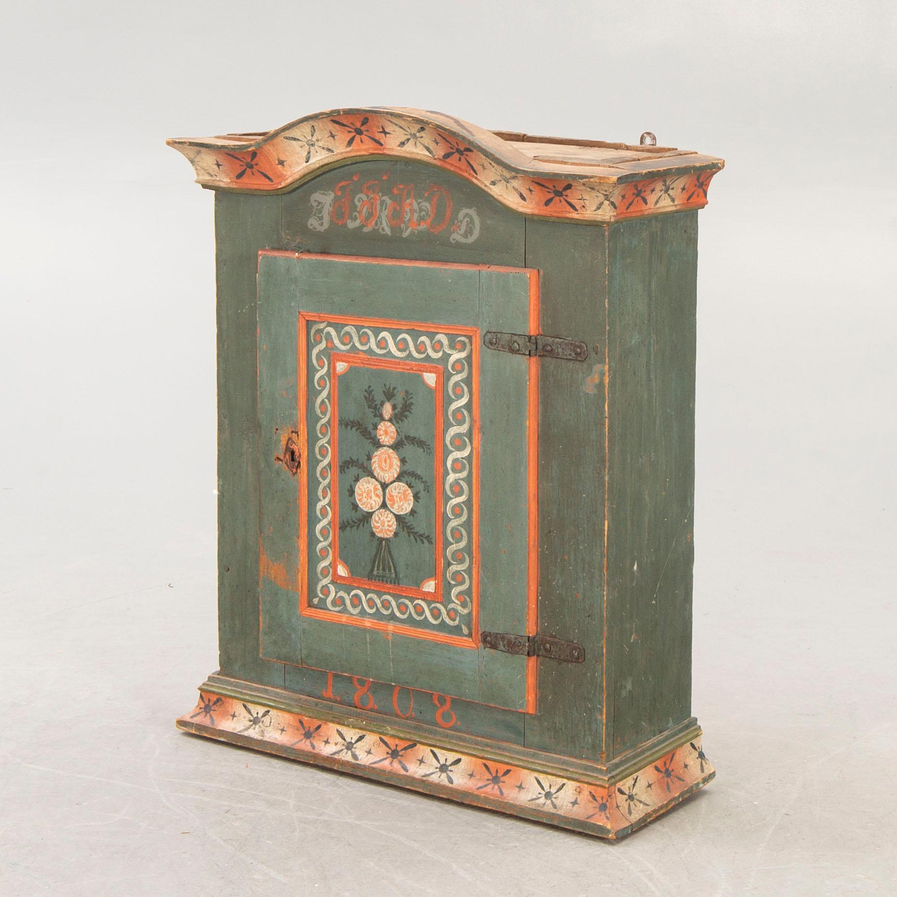 A painted Swedish wall cabinet dated 1808.