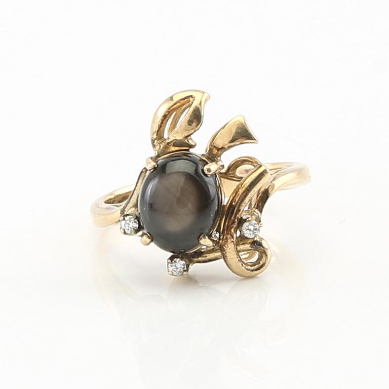 Ring and earrings in 14K gold with round brilliant-cut diamonds and likely natural black star sapphires.