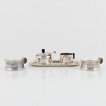 A 4-piece German silver coffee service and two German glass and silver plated tea cups, 1930's.