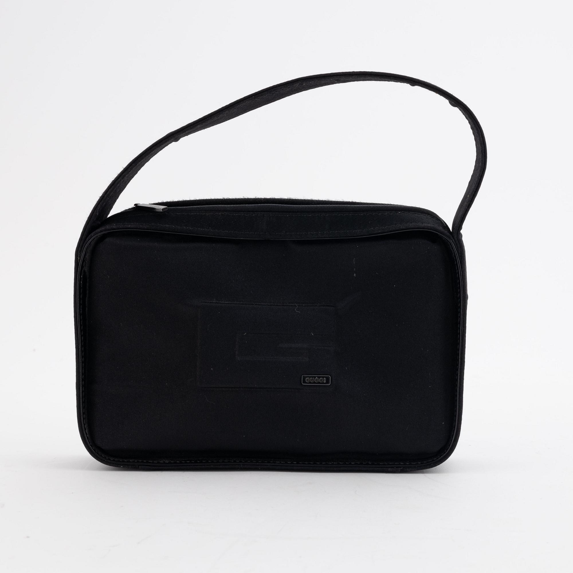 Gucci, a black satin handbag.