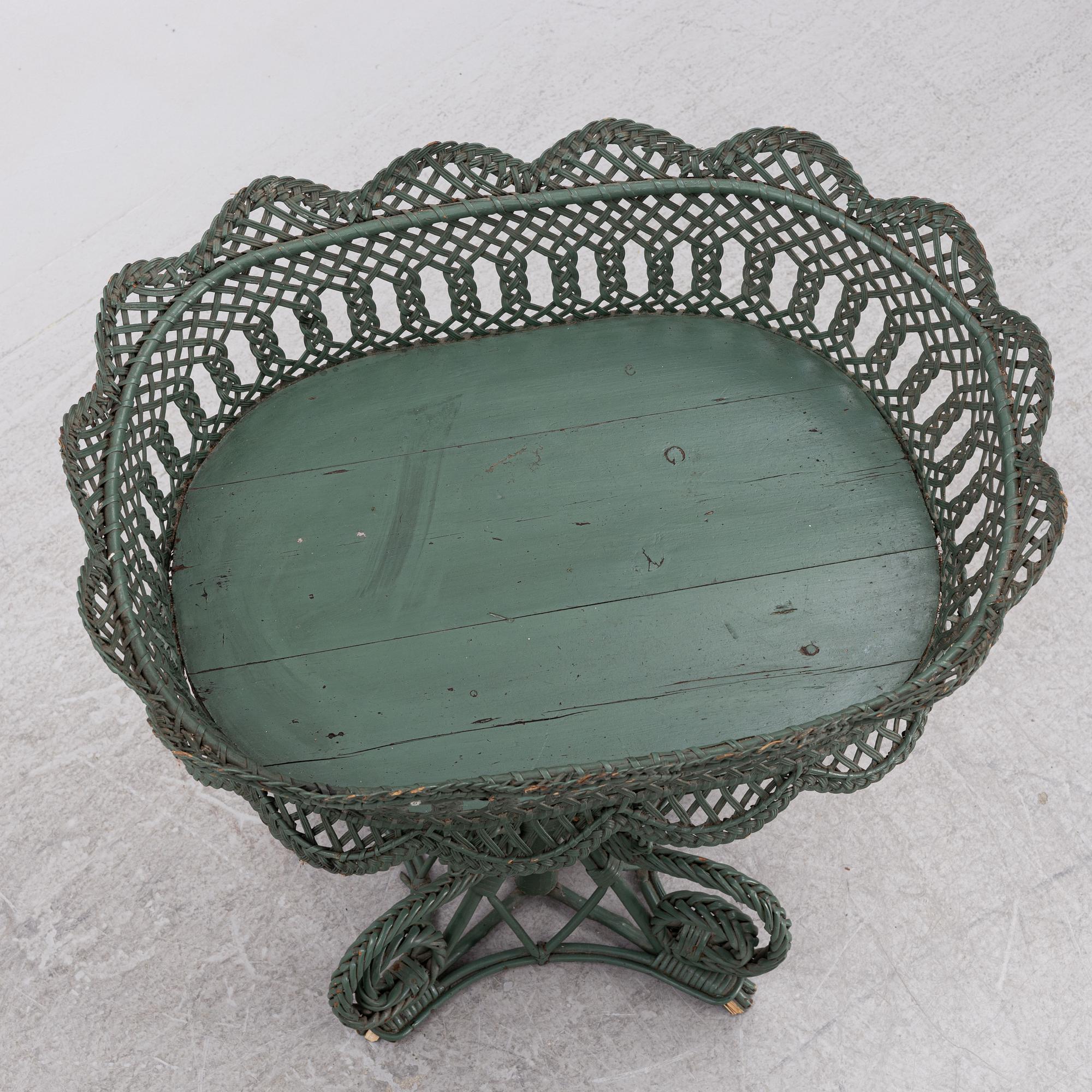A wicker flower table, early 20th century.