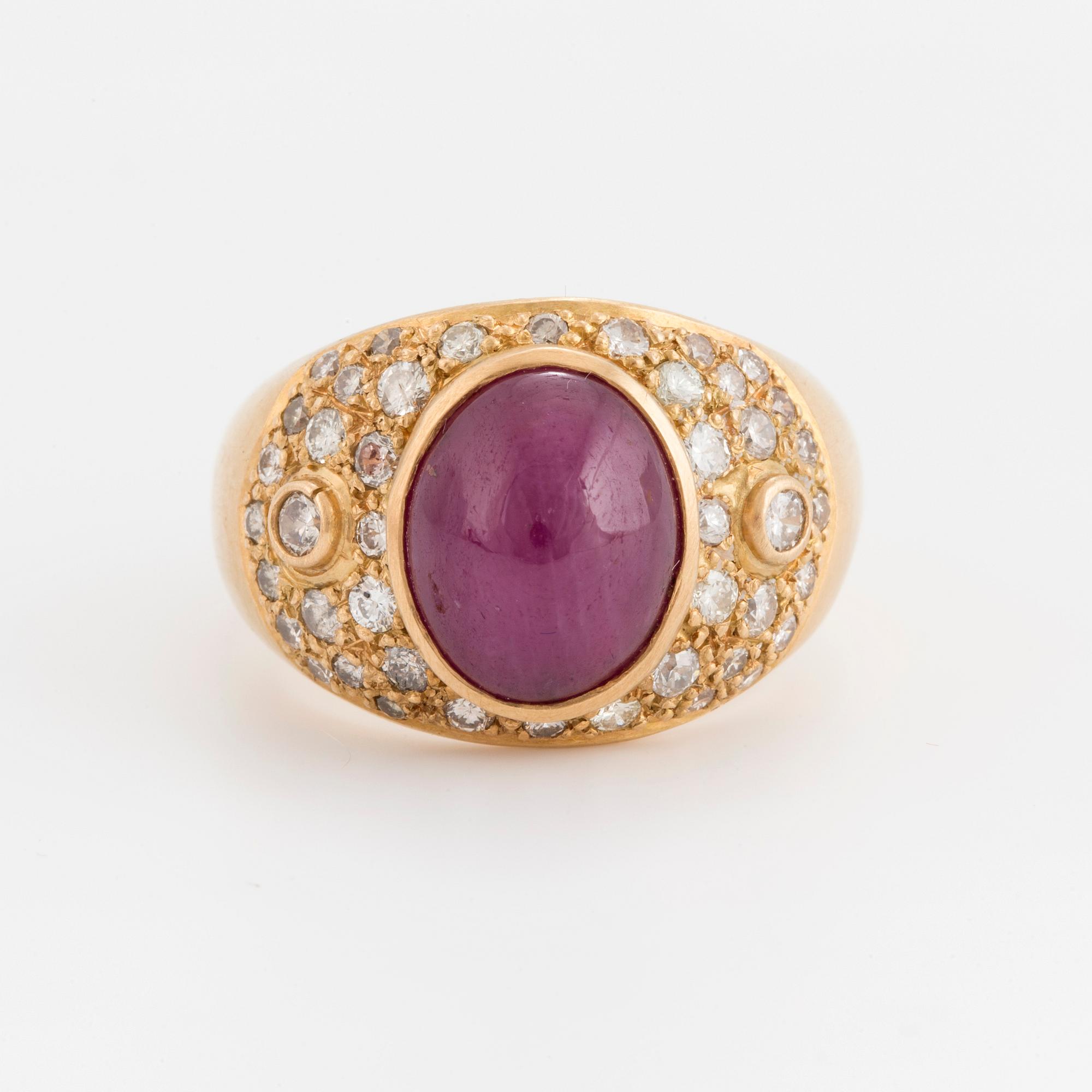 A cabochon cut opaque ruby and brilliant cut diamond ring.