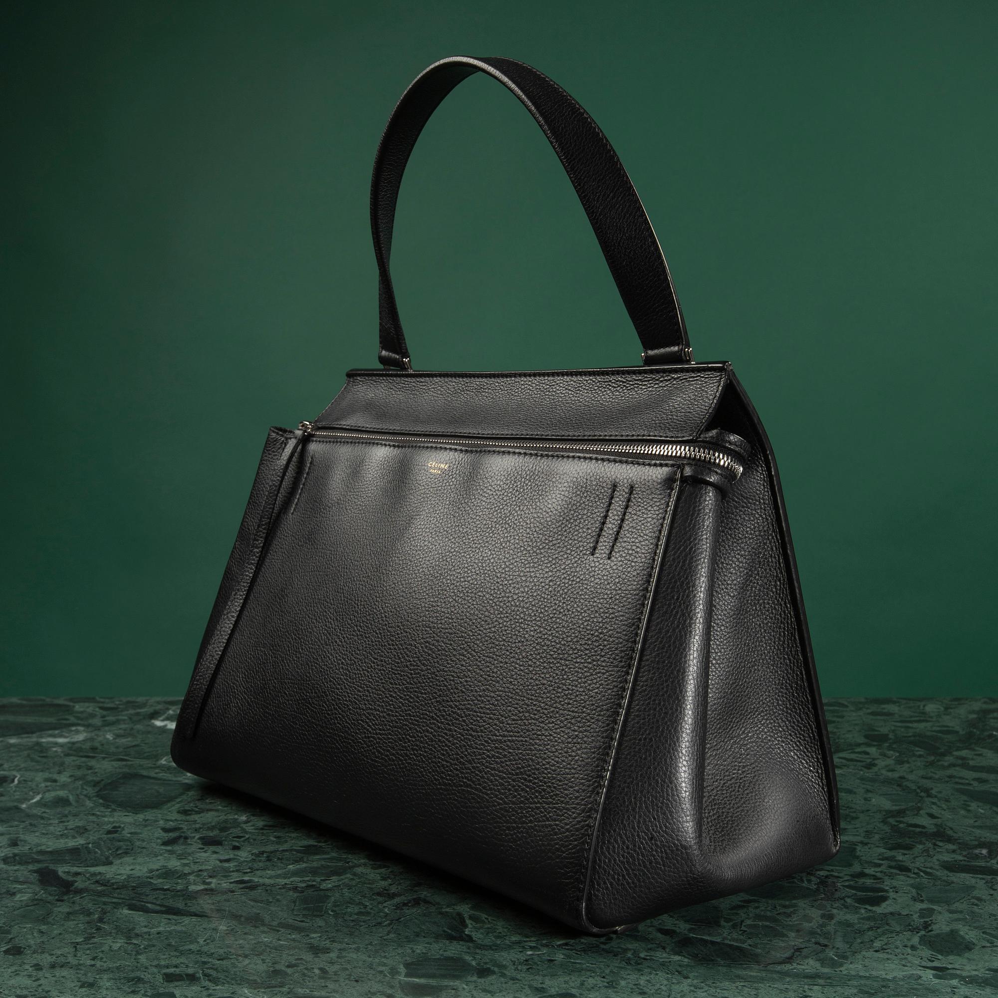 HANDBAG, "Large Edge Bag", Céline, 2013. Black leather with silver-tone hardware, pocket at back with snap closure.