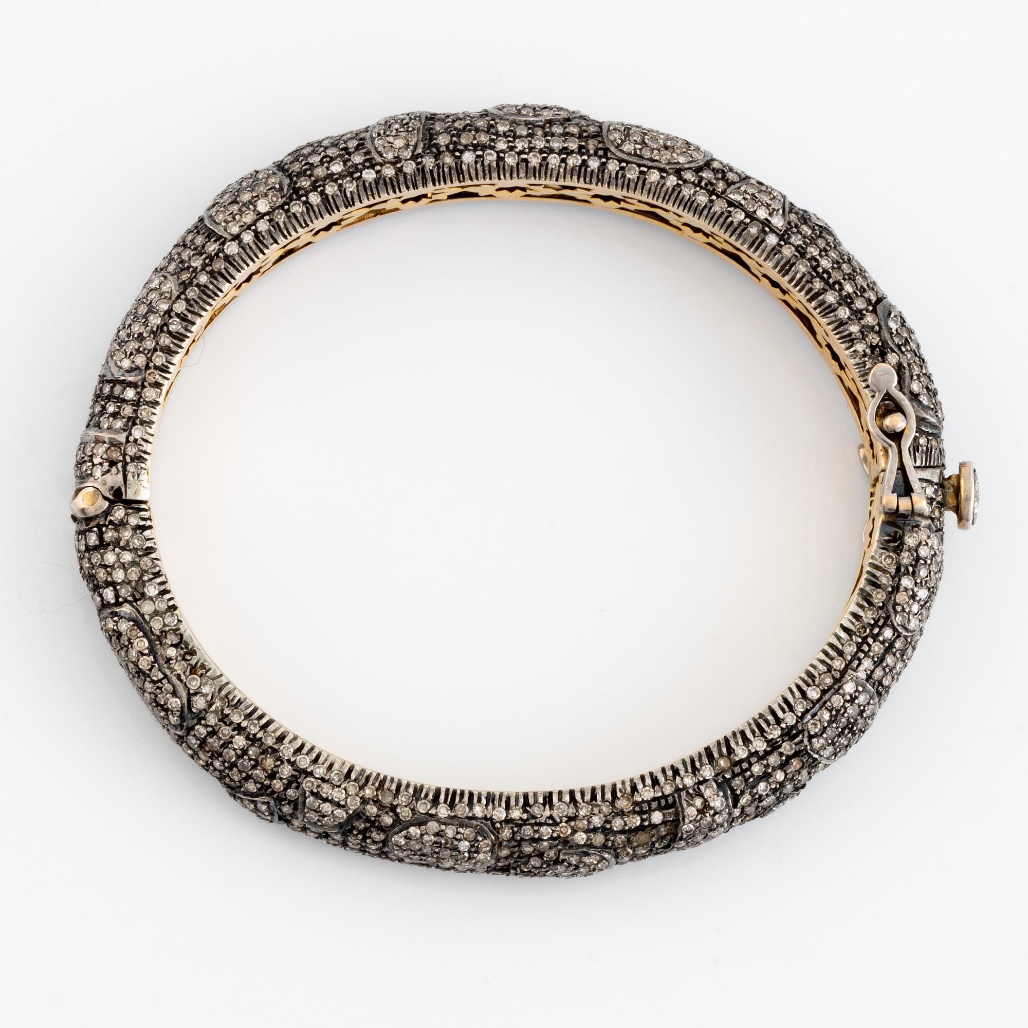 Silver and giltet gold and eight cut diamond bangle.