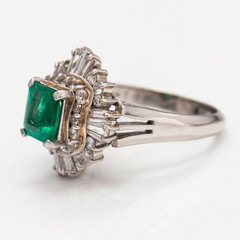 A platinum ring with a ca. 1.15 ct emerald and ca. 1.00 cts of diamonds in total.