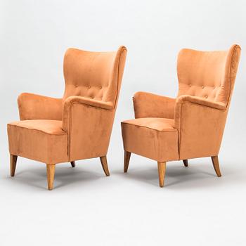 A pair of 1950's open arm chairs for Oy Paul Boman Ab.