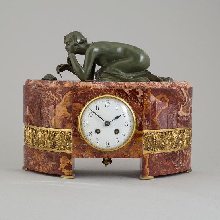 An early 20th century mantle clock with a bronze sculpture signed M. Charny.