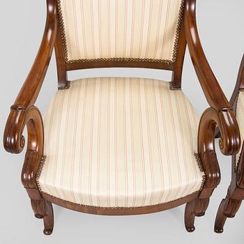 A pair of French open-arm chairs, first half of the 19th century.