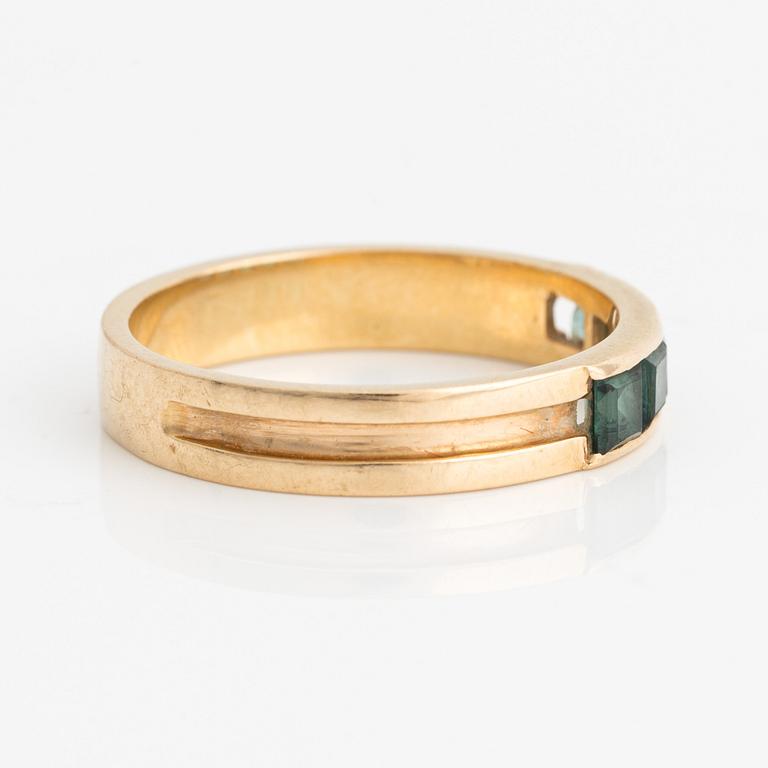 Ring with square-cut green stones.