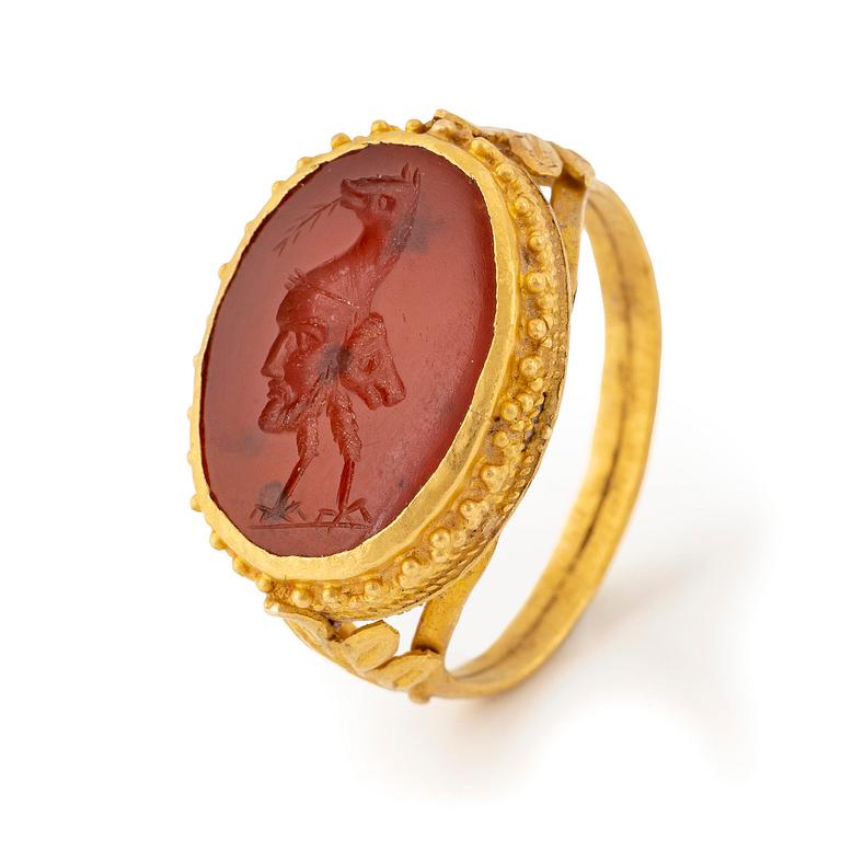 A possibly Etruscan gold and carnelian signet ring.