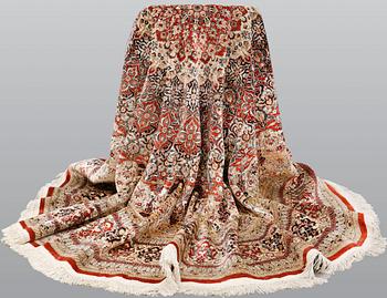 An Oriental silk rug, diameter 256 cm.