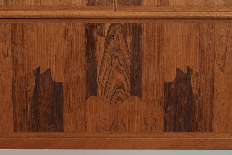 A Carl Malmsten mahogany cabinet with inlays of different types of wood, signed and dated 1958.