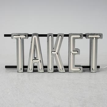 A neon sign "TAKET", late 20th century/21st century.