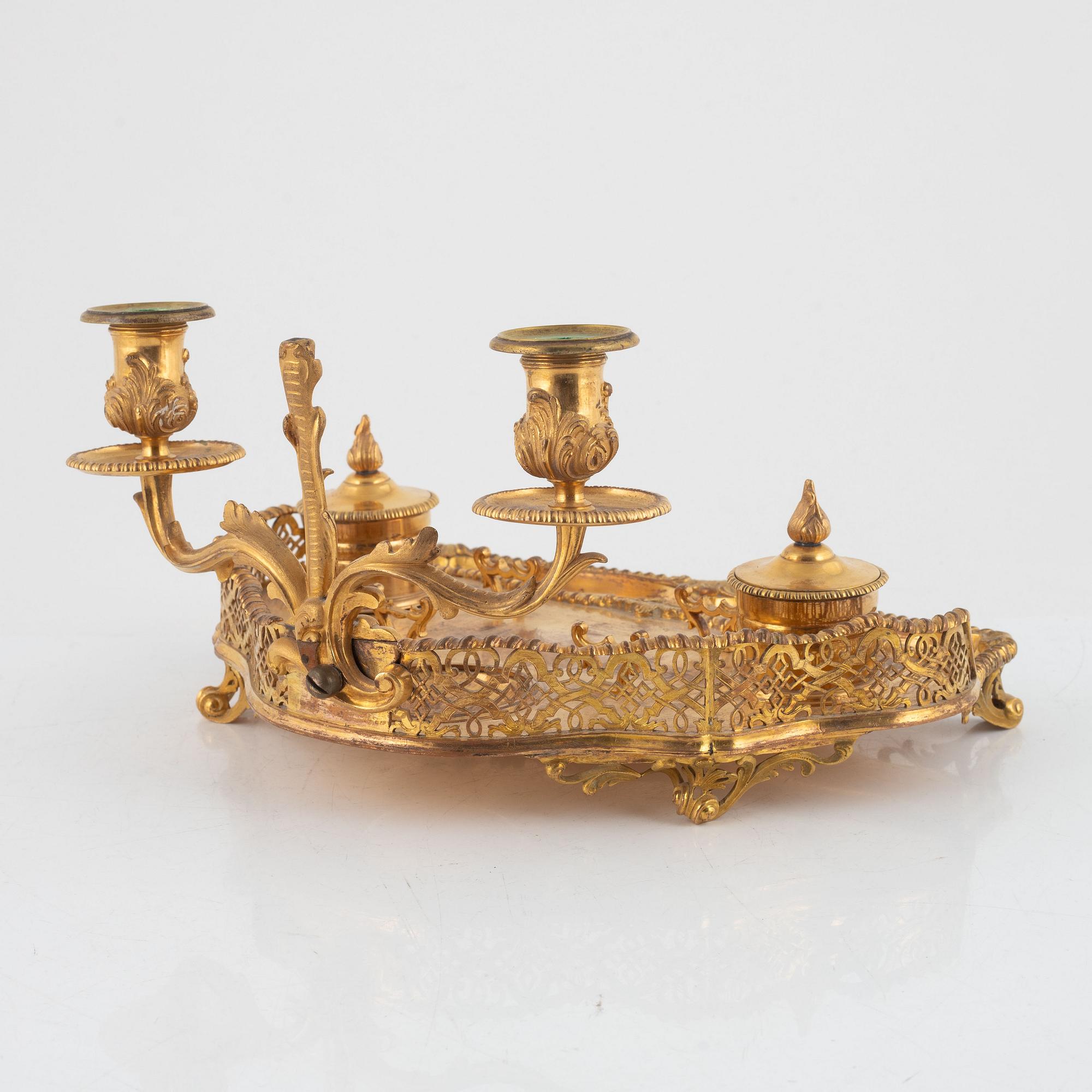 A gilt inkwell and candle holder, around 1900.