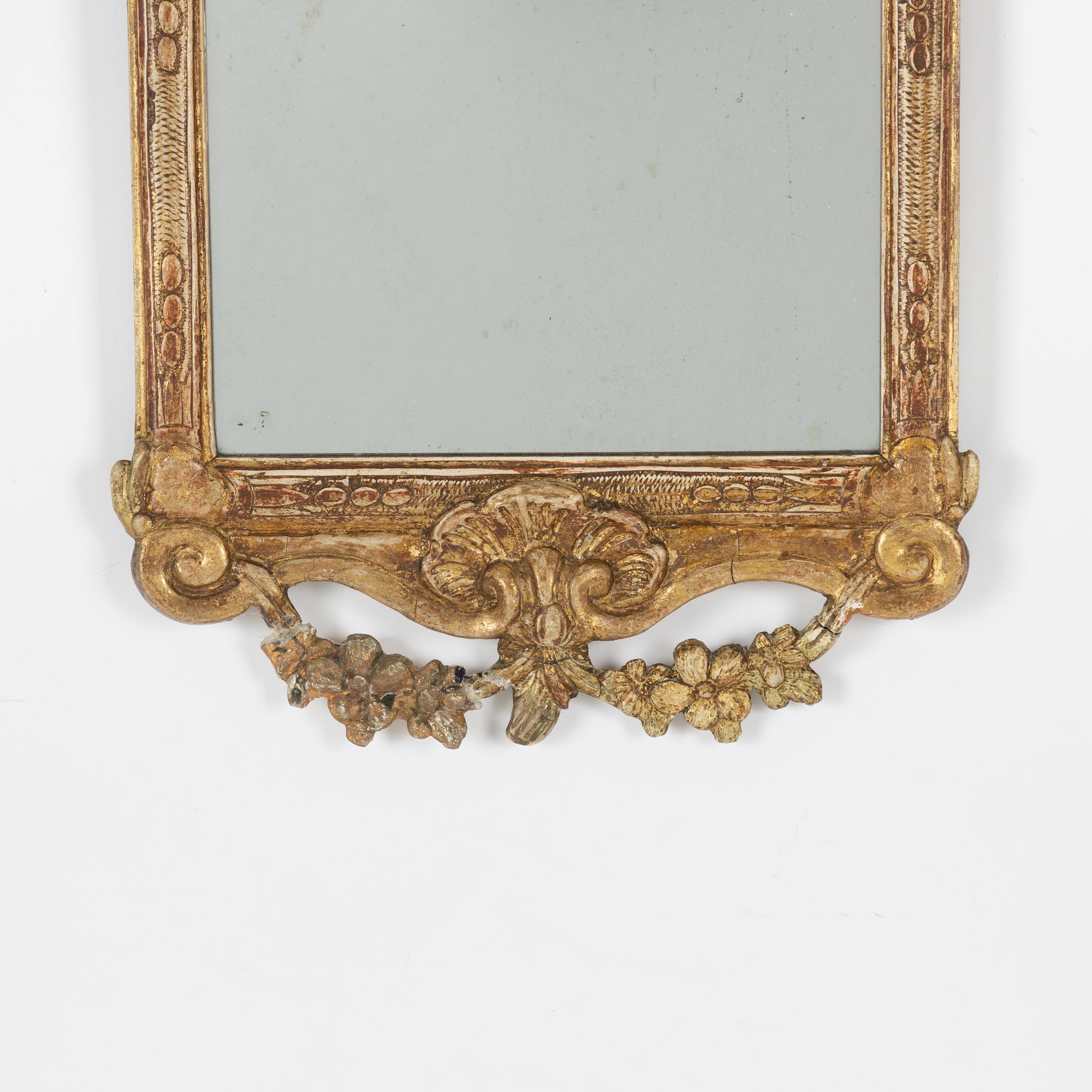 A Gustavian carved giltwood mirror, Stockholm, late 18th century.