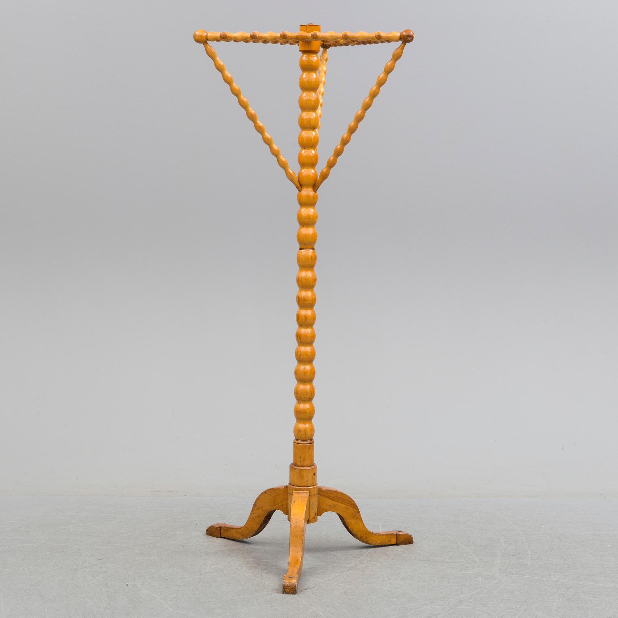 A turned birch clothes hanger, circa 1900.