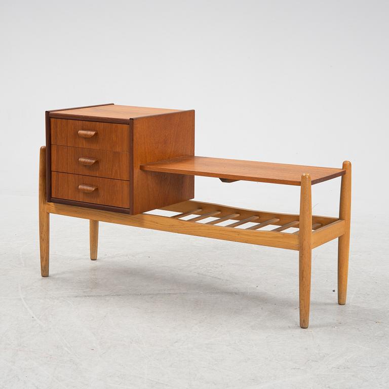 A teak chest of drawers with shelves, 1950's/60's.