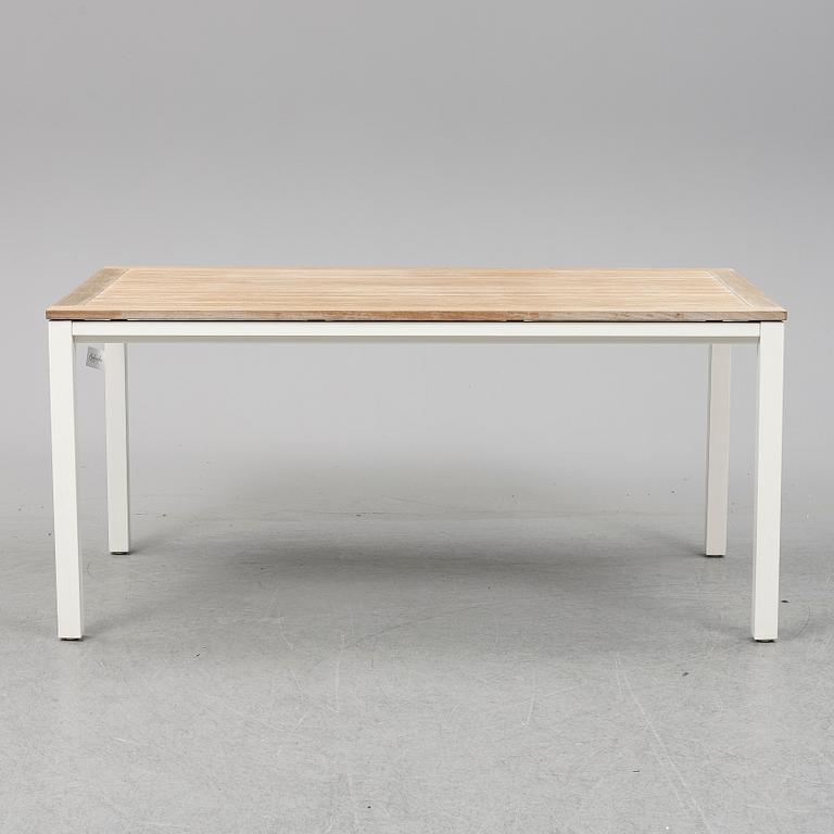 A garden table with four chairs, Gloster.
