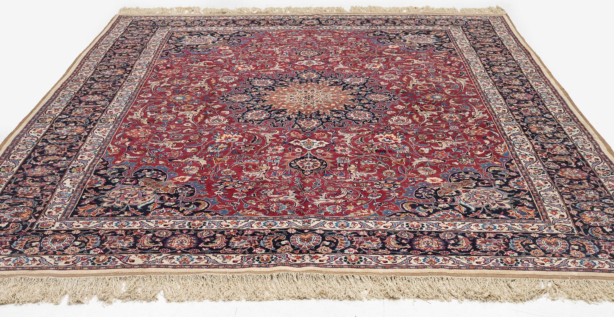 A semi-antique Mashad carpet, signed Saber, c. 401 x 300 cm.