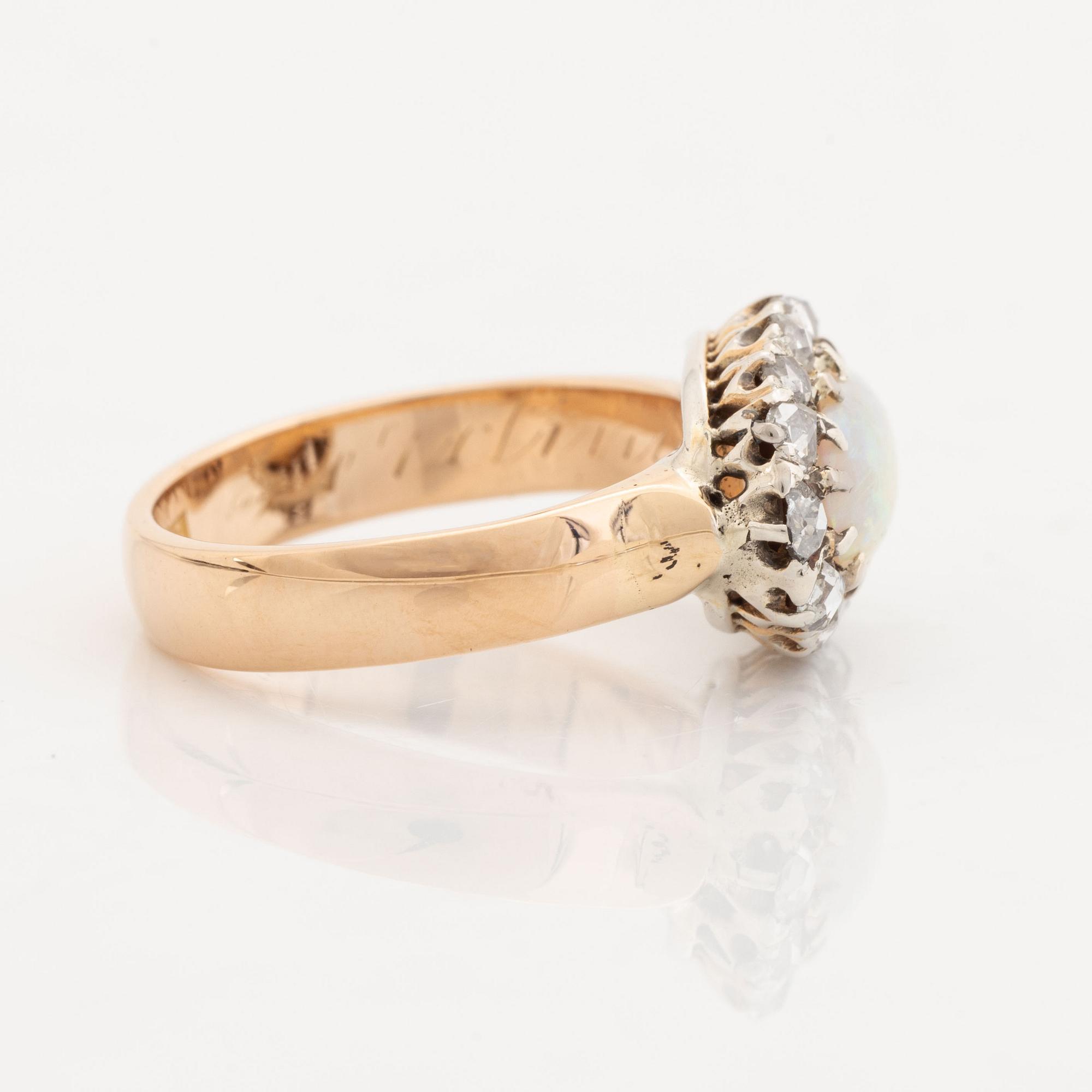 An 18K gold and opal ring set with rose-cut diamonds.