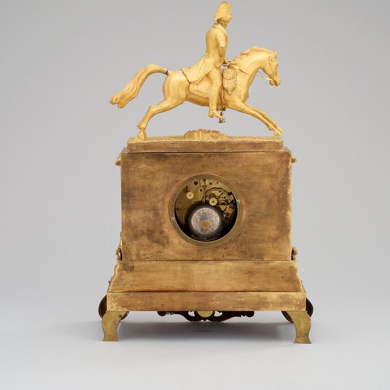 A Swedish Empire Equestrian gilt bronze mantel clock depicting king Karl XIV Johan.