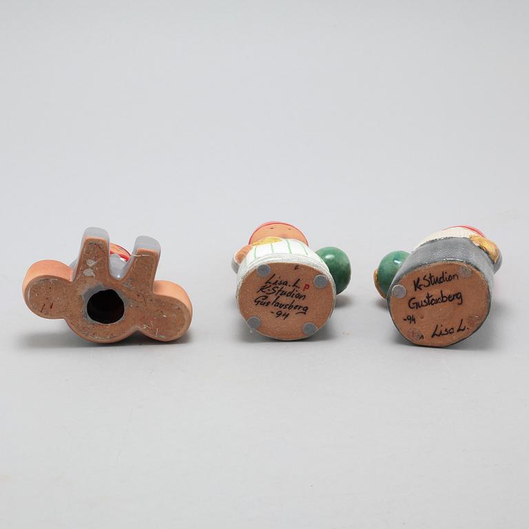 Three ceramic candlesticks by Lisa Larson for Gustavsberg, partly signed.