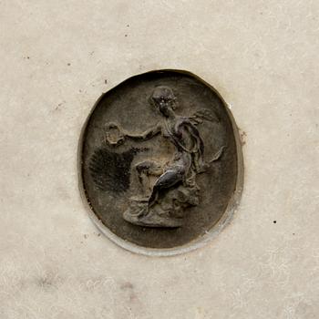 VÄGGRELIEFER, 2 st. Stenmassa, bär otydl påskrift 1878.